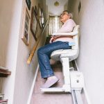 senior woman using automatic stair lift vs home elevator